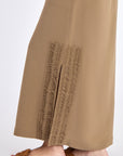 Close-up detail of the premium linen blend fabric and the angled patch pocket on the Taupe Indigo Skirt.