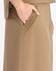 Close-up detail of the premium linen blend fabric and the angled patch pocket on the Taupe Indigo Skirt.
