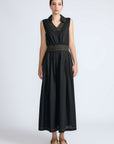 Isidora Dress in Black – Sleeveless midi cotton dress with shirt collar V-neckline, tiered silhouette, and hidden side pockets.