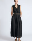 Isidora Dress in Black – Sleeveless midi cotton dress with shirt collar V-neckline, tiered silhouette, and hidden side pockets.