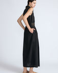 Isidora Dress in Black – Sleeveless midi cotton dress with shirt collar V-neckline, tiered silhouette, and hidden side pockets.