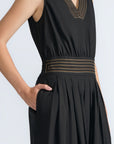 Isidora Dress in Black – Sleeveless midi cotton dress with shirt collar V-neckline, tiered silhouette, and hidden side pockets.
