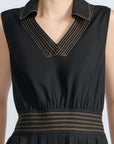 Isidora Dress in Black – Sleeveless midi cotton dress with shirt collar V-neckline, tiered silhouette, and hidden side pockets.