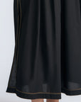 Isidora Dress in Black – Sleeveless midi cotton dress with shirt collar V-neckline, tiered silhouette, and hidden side pockets.
