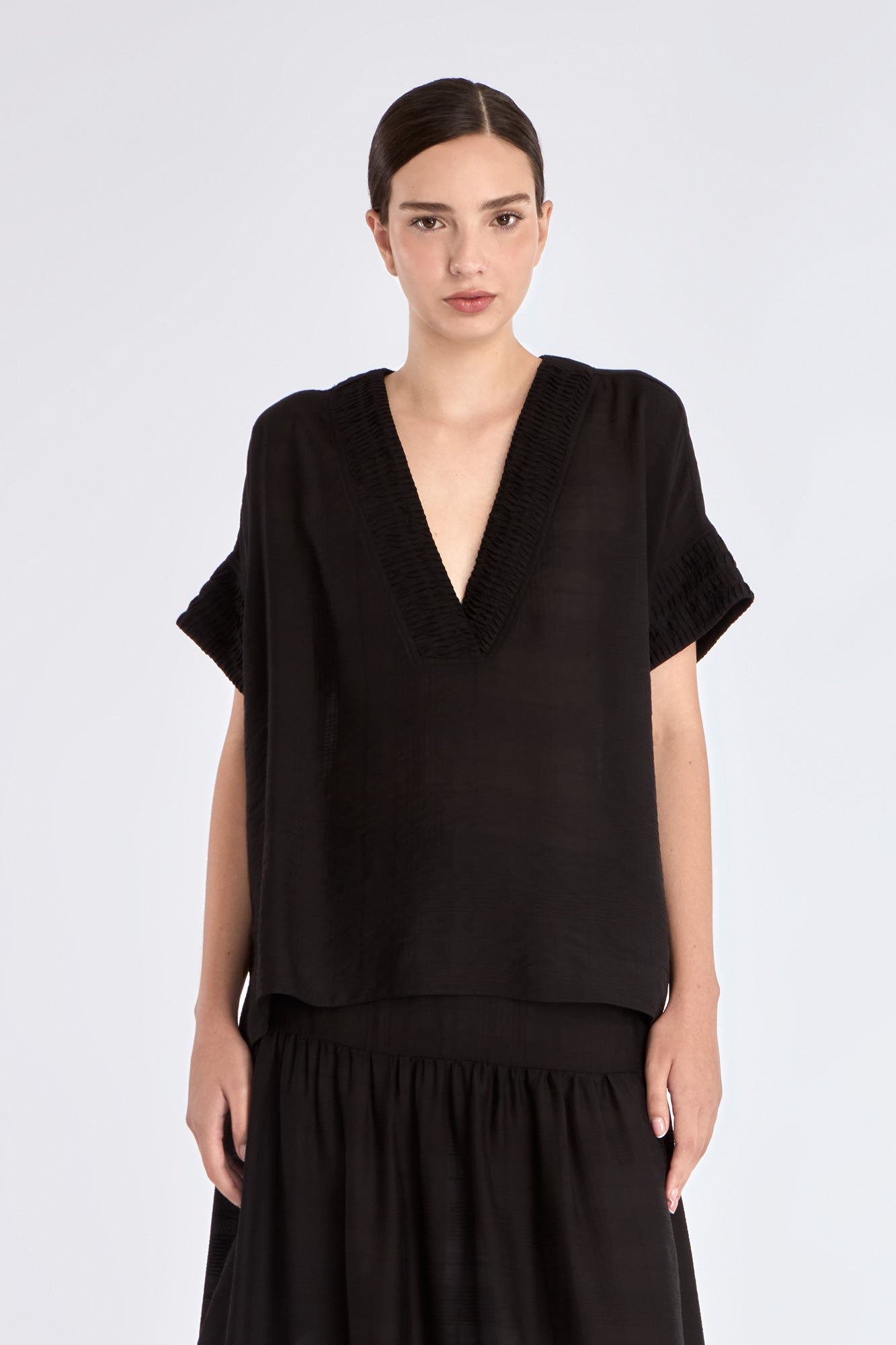 Front view of the Ivy Blouse in black, showcasing its classic V-neckline and relaxed silhouette.