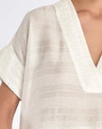 Ivy Blouse in Off White – V-neck short sleeve blouse with tonal hem detail and relaxed silhouette in rayon and nylon blend.