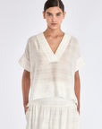 The Ivy Blouse in Off White, featuring its clean V-neckline and refined silhouette.