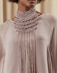 A close-up of the Lara Peto in Rose, highlighting the hand-embroidery of beads and crystals on the macrame.