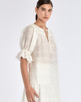 Side view of the Off White Lauren Blouse, showcasing the gathered cuff and relaxed silhouette.