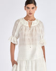 The Lauren Blouse in Off White, featuring its unique V-slit neckline with adjustable drawstrings.