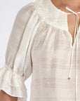 Detail shot of the V-slit neckline with its metal-tipped drawstrings on the Off White Lauren Blouse.