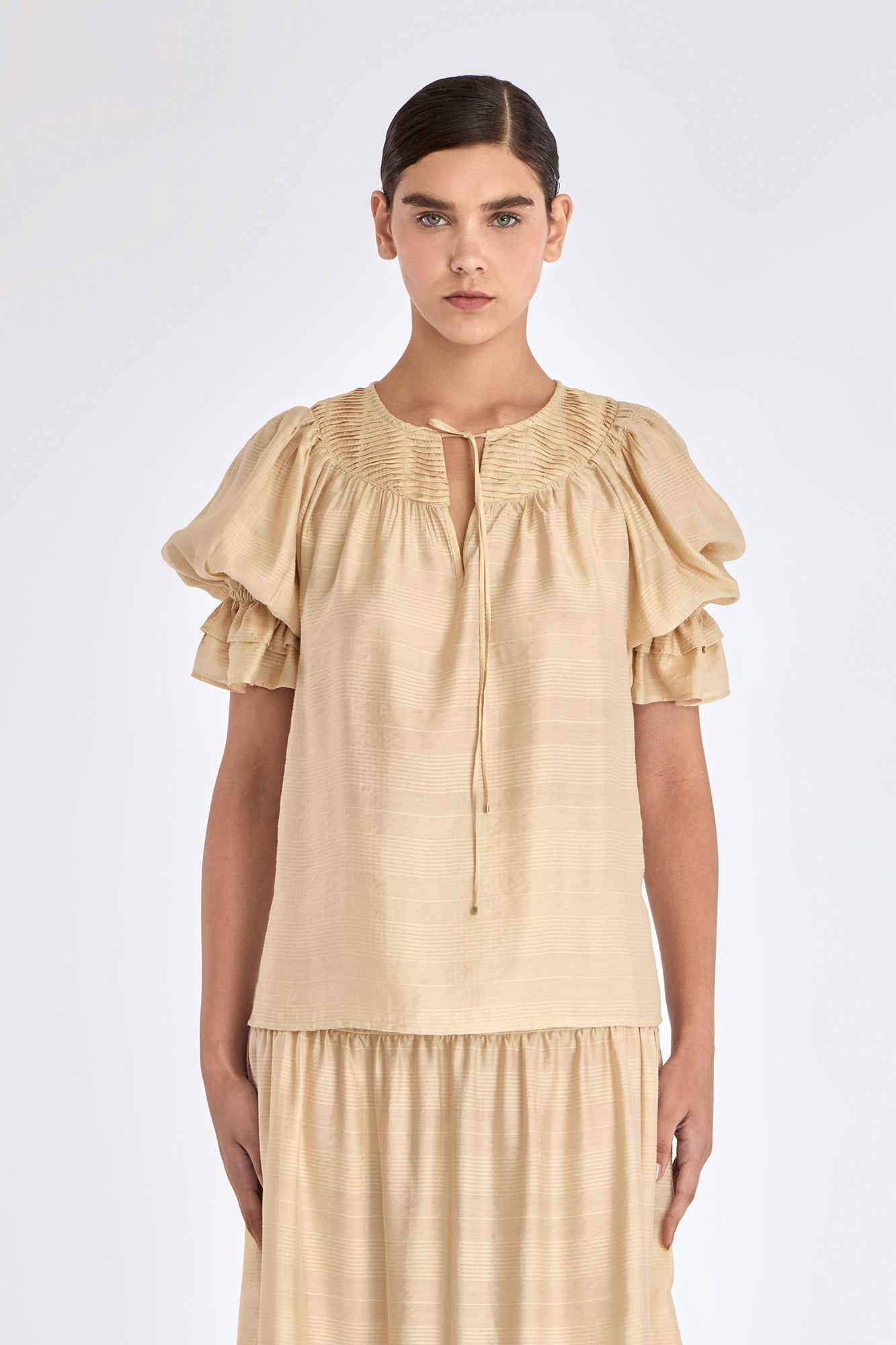 Front view of the Lauren Blouse in Vanilla, showcasing its adjustable V-slit neckline.