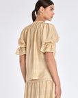 Clean back silhouette of the Lauren Blouse, showing the elegant drape of the fabric.