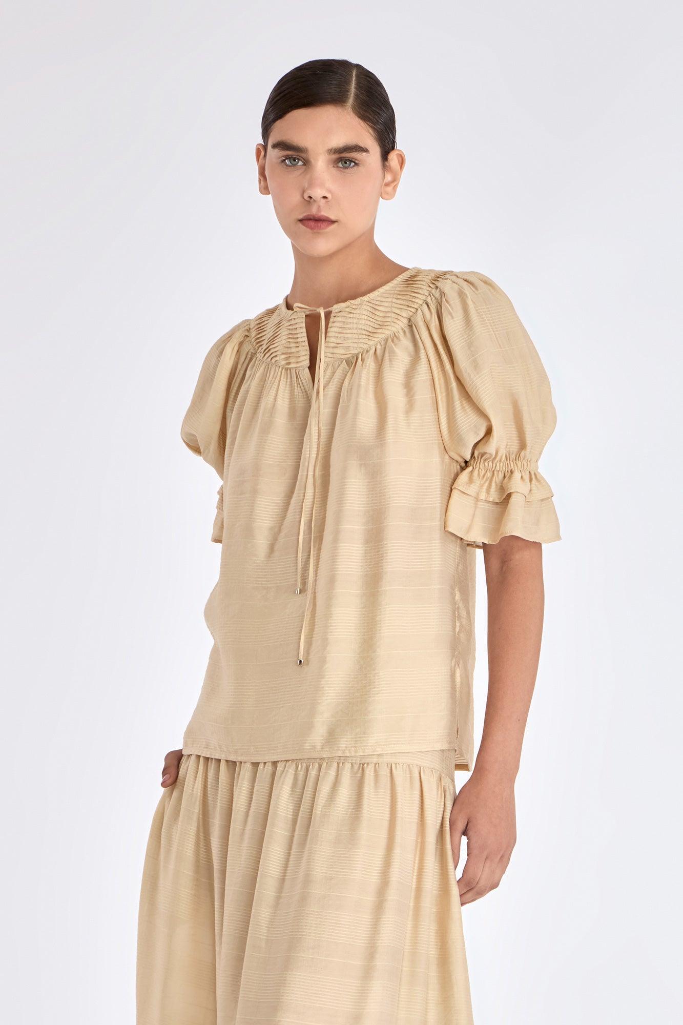 Front view of the Lauren Blouse in Vanilla, showcasing its adjustable V-slit neckline.