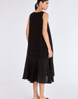 Clean back view of the essential black Lenox Godet Dress.
