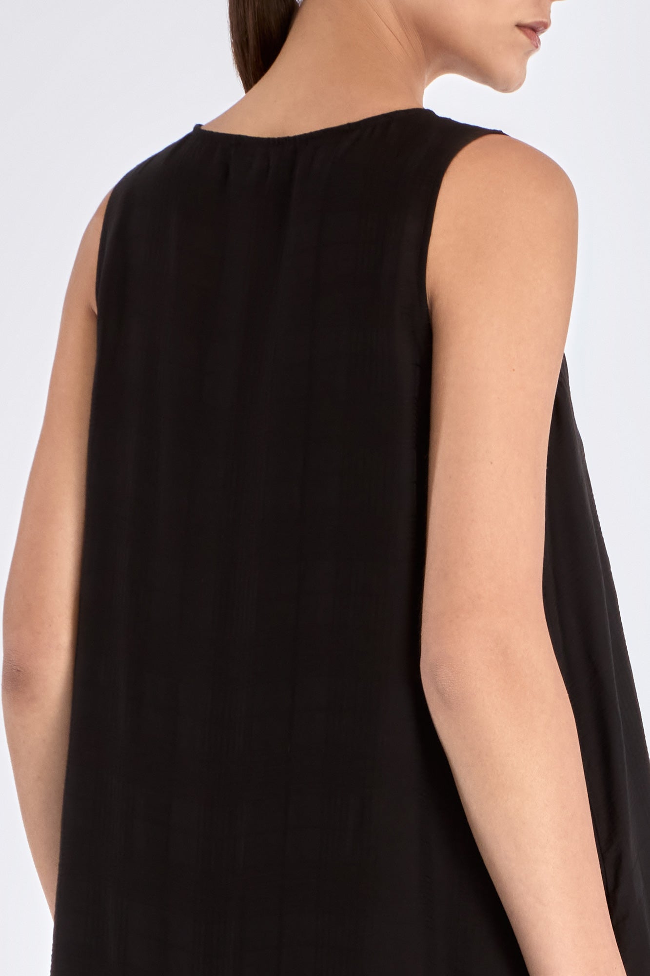 Clean back view of the essential black Lenox Godet Dress.