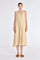 Front view of the Lenox Dress in Vanilla, showcasing its V-neckline and flowing godet skirt.