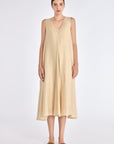 Front view of the Lenox Dress in Vanilla, showcasing its V-neckline and flowing godet skirt.