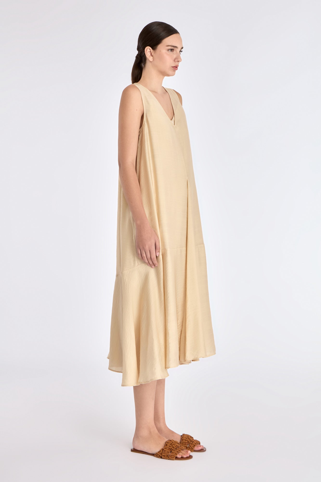 Side profile of the Vanilla Lenox Dress, highlighting the graceful movement and flare of the godet construction.
