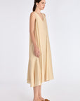 Side profile of the Vanilla Lenox Dress, highlighting the graceful movement and flare of the godet construction.