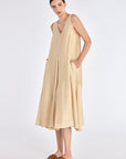 Front view of the Lenox Dress in Vanilla, showcasing its V-neckline and flowing godet skirt.