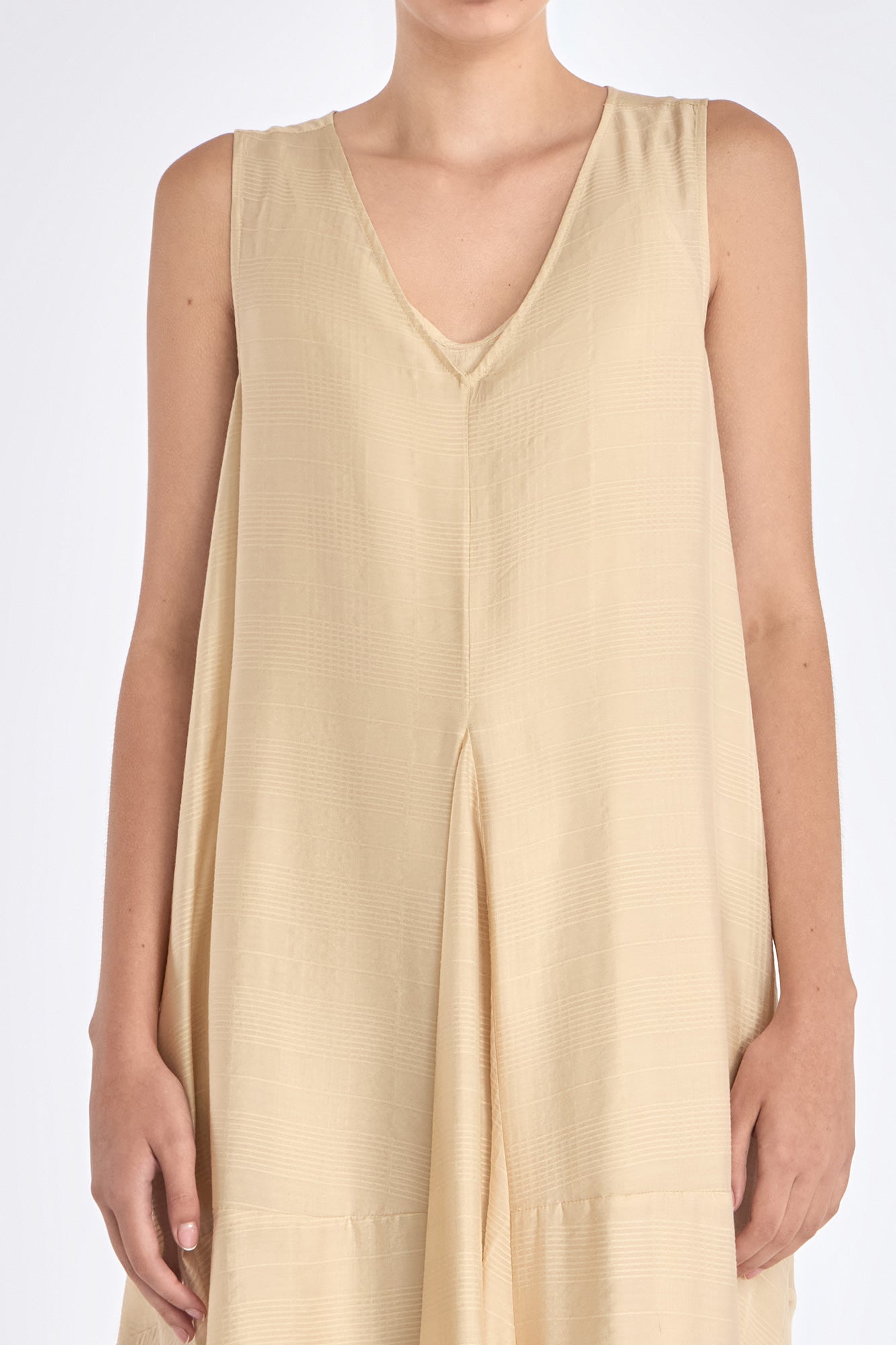 Front view of the Lenox Dress in Vanilla, showcasing its V-neckline and flowing godet skirt.