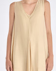 Front view of the Lenox Dress in Vanilla, showcasing its V-neckline and flowing godet skirt.