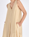Front view of the Lenox Dress in Vanilla, showcasing its V-neckline and flowing godet skirt.