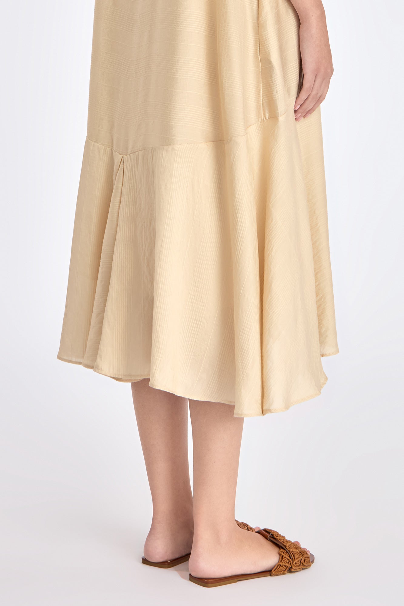 Close-up on the woven texture and godet paneling on the lower part of the Vanilla Lenox Dress.