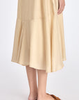Close-up on the woven texture and godet paneling on the lower part of the Vanilla Lenox Dress.