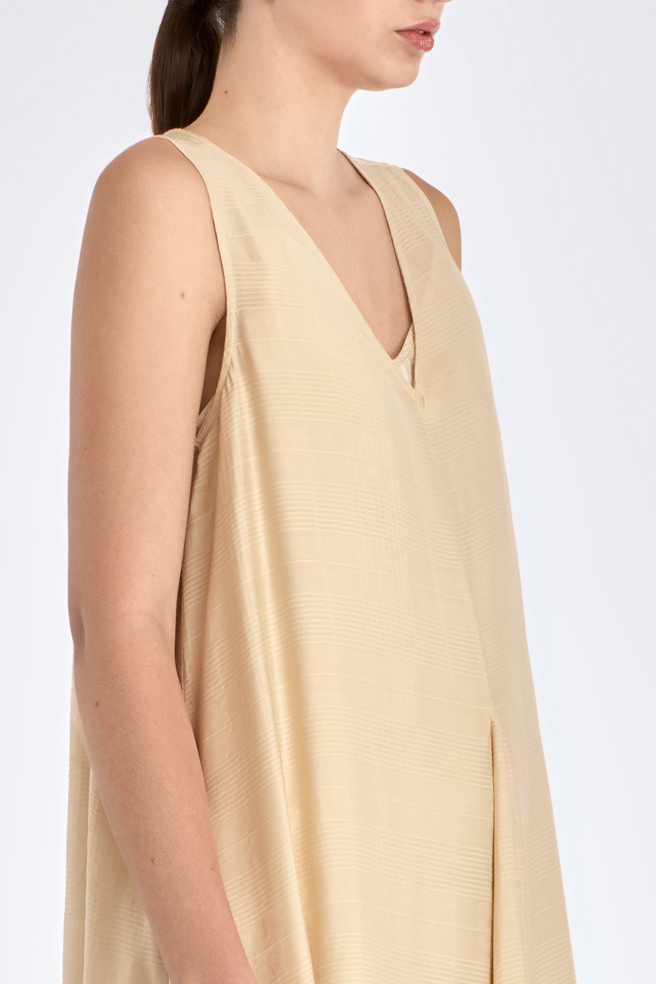 Side profile of the Vanilla Lenox Dress, highlighting the graceful movement and flare of the godet construction.