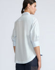 Lina Blouse in Light Blue – Cotton shirt with shirt collar, hidden button closure, ¾ balloon sleeves, and elastic cuffs.