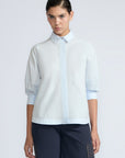 Lina Blouse in Light Blue – Cotton shirt with shirt collar, hidden button closure, ¾ balloon sleeves, and elastic cuffs.