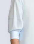 Lina Blouse in Light Blue – Cotton shirt with shirt collar, hidden button closure, ¾ balloon sleeves, and elastic cuffs.