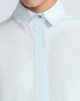 Lina Blouse in Light Blue – Cotton shirt with shirt collar, hidden button closure, ¾ balloon sleeves, and elastic cuffs.
