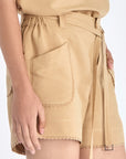 Lira Short in Camel – Linen mid-rise shorts with patch pockets, belt with metal tips, and tone-on-tone trims.