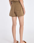 Lira Short in Taupe – Chic mid-rise linen shorts with elasticated waistband, metal-tipped belt, and patch pocket detailing.