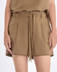 Lira Short in Taupe – Chic mid-rise linen shorts with elasticated waistband, metal-tipped belt, and patch pocket detailing.