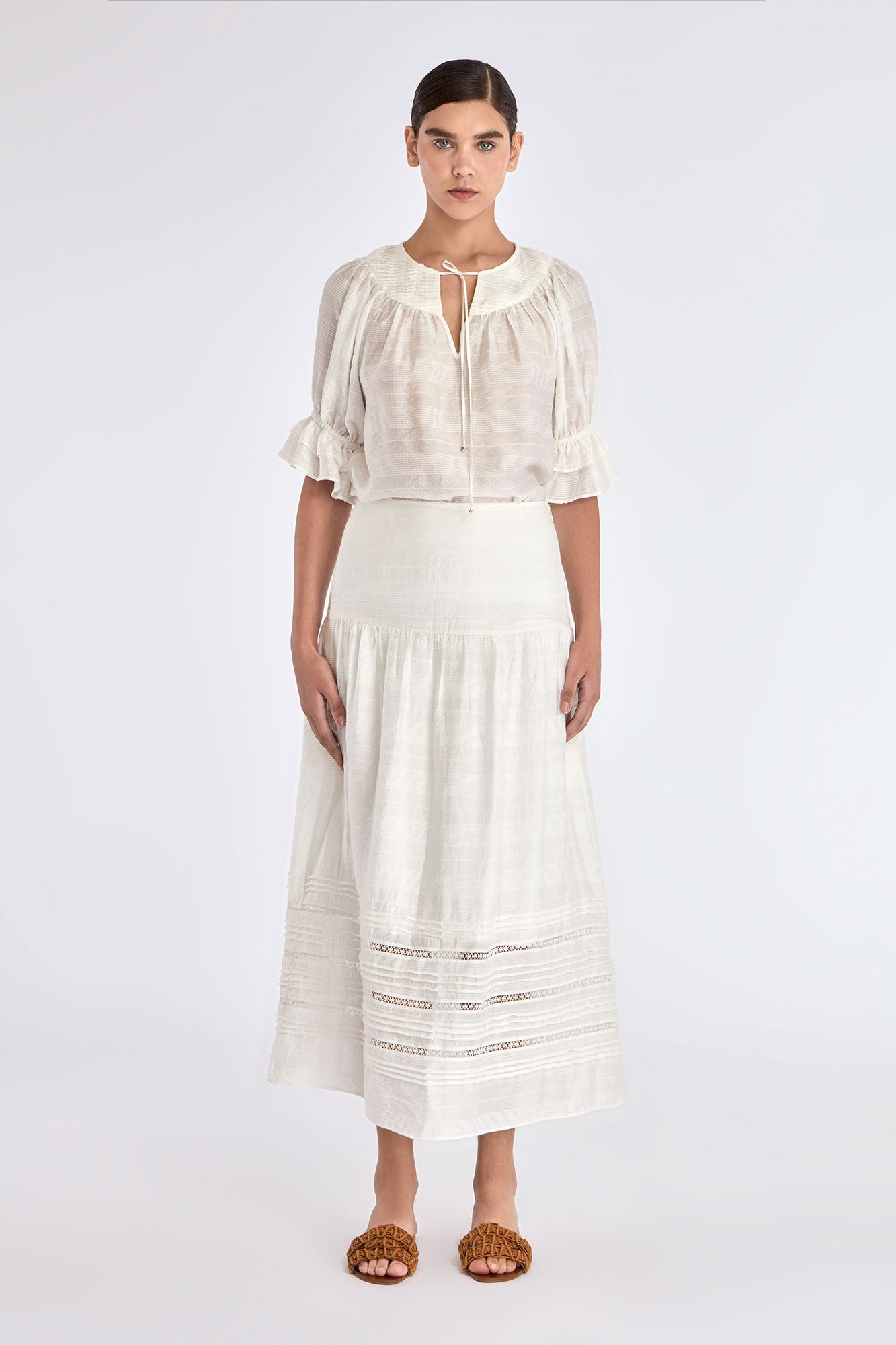 Model wearing the Luanda High-Waist Skirt in Off White.