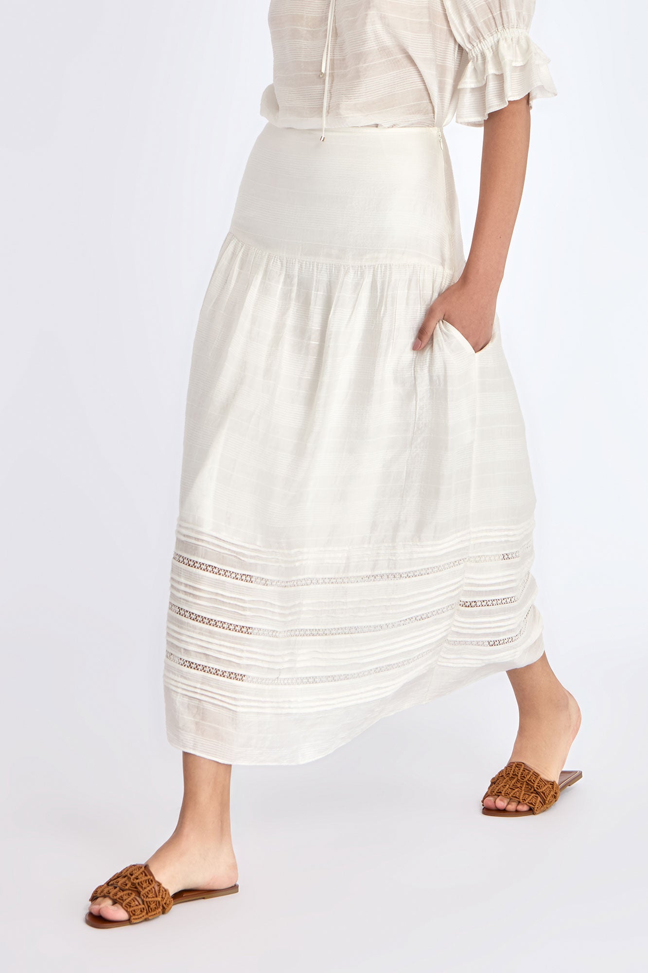 Model wearing the Luanda High-Waist Skirt in Off White.