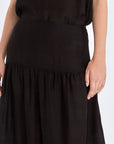 Subtle tonal trim and gathered fabric detail of the black Luanda Skirt.
