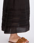 Subtle tonal trim and gathered fabric detail of the black Luanda Skirt.