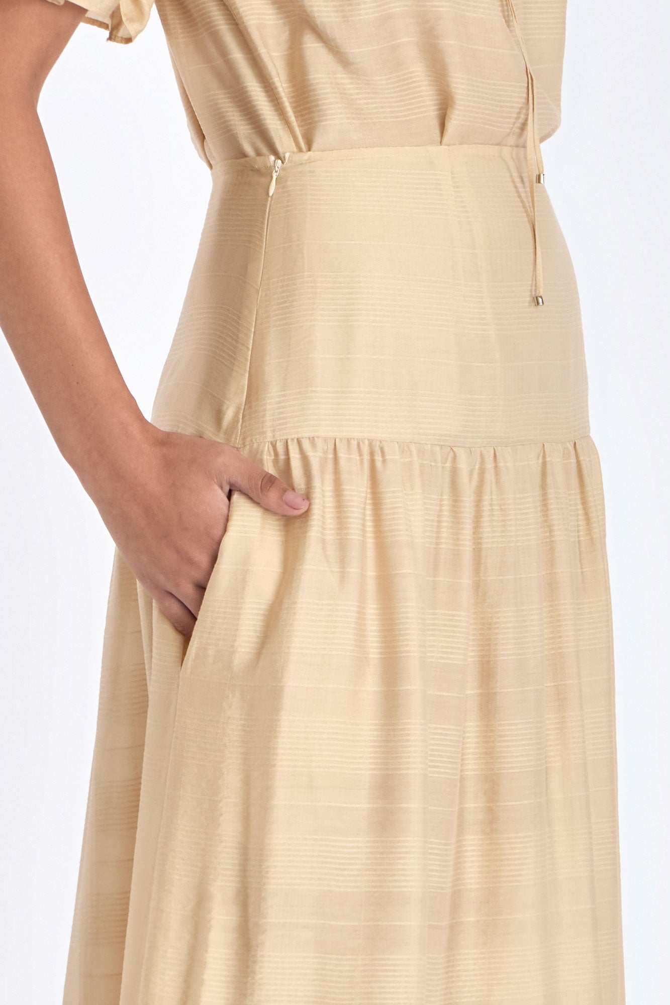 Close-up of the tonal trim and stitching detail on the hem of the Vanilla Luanda Skirt
