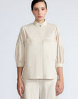 Magali Blouse in Prestine – Pima cotton blouse with Neru collar, hidden front buttons, patch pockets, and ¾ sleeves with semi-elastic cuffs.