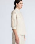 Magali Blouse in Prestine – Pima cotton blouse with Neru collar, hidden front buttons, patch pockets, and ¾ sleeves with semi-elastic cuffs.