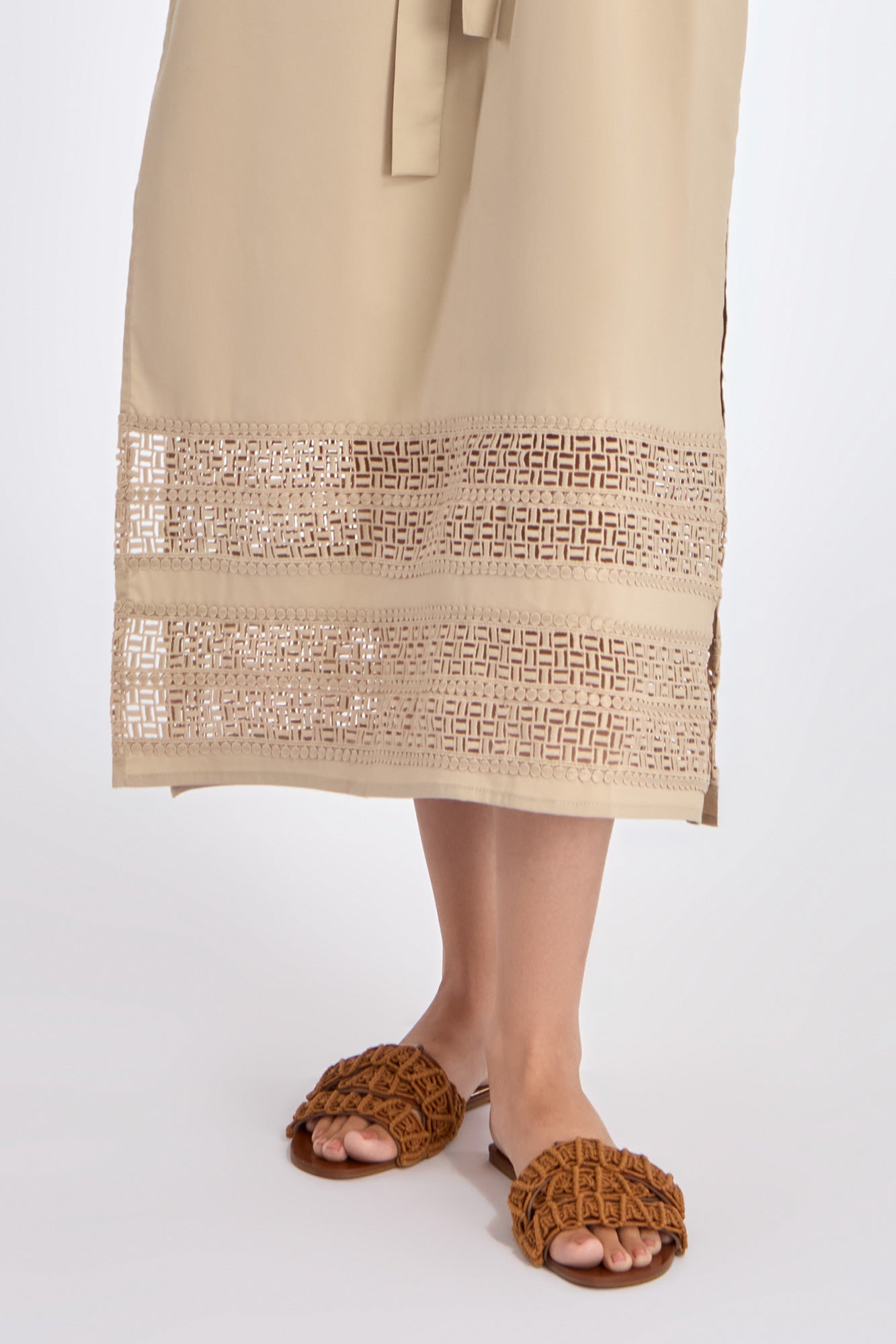 Detailed view of the hem on the Ecru Maki Dress, highlighting the subtle tone-on-tone trim and the quality of the stretch cotton weave.