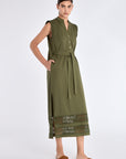 Side profile of the Olive Maki Dress, highlighting the clean lines of its midi silhouette.