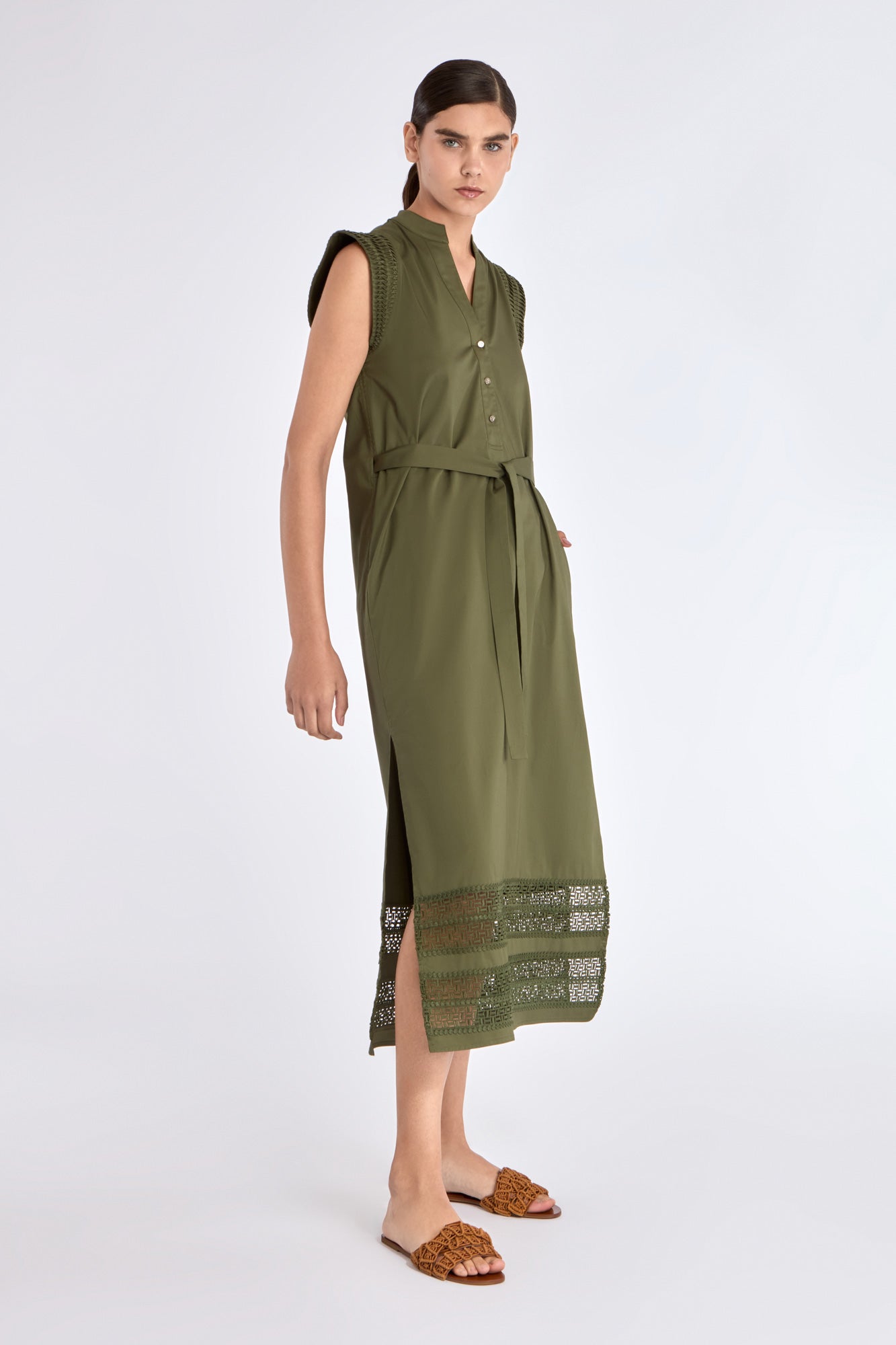 Side profile of the Olive Maki Dress, highlighting the clean lines of its midi silhouette.
