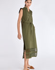 Side profile of the Olive Maki Dress, highlighting the clean lines of its midi silhouette.