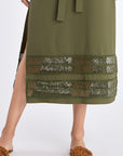Close-up detail of the tonal trim at the hem of the Olive Maki Dress, showcasing the texture of the premium stretch cotton fabric.
